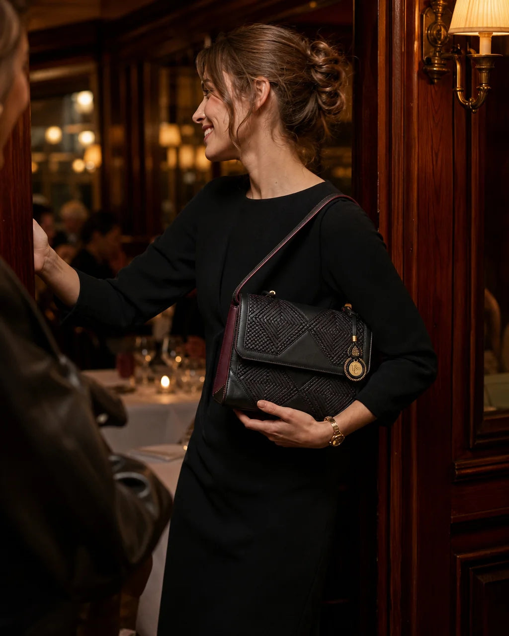 Professional fashion lookbook photograph, 4:5. The "Parisienne" baguette in black grainé leather wit